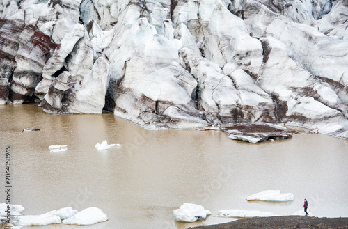 Person walking along gravel road through icelandic landscape Iceland