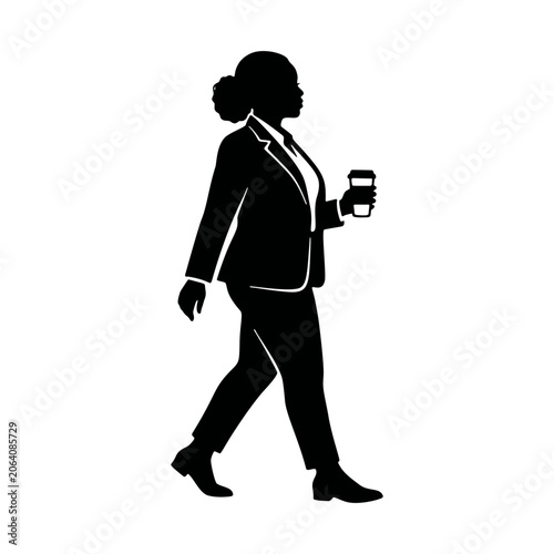 Silhouette of a professional woman in a suit walking with a coffee cup.