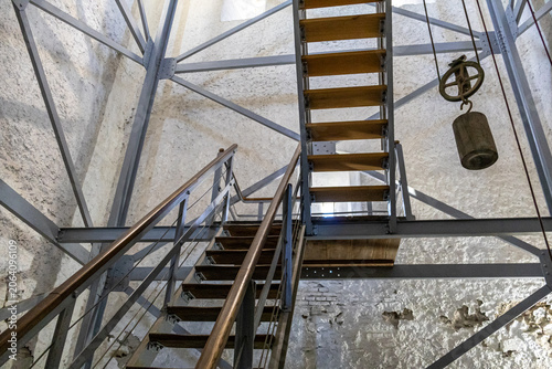 Canvas Print Industrial Metal Stairs and Heavy Pulley Counterweight in Tower