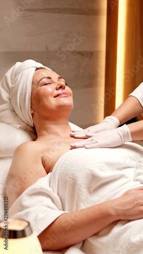 Woman receiving professional body massage in wellness spa center. Relaxed female client enjoying beauty treatment procedure. Holistic health and body care session.
