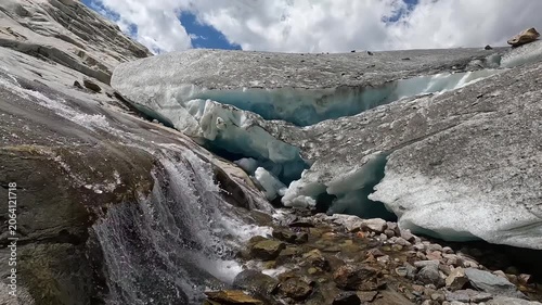 Glacial Meltwater Cascade Flowing Near Blue Ice Serac Wall at Aletsch Glacier Valais Switzerland