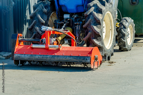 Принти на полотні red tiller is attached to blue tractor for soil preparation
