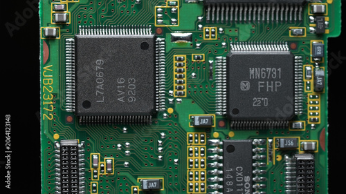 classic green motherboard with chipsets, memory modules, transistors and contacts