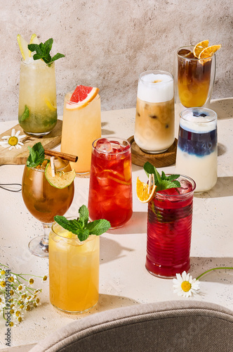 Summer drinks composition with lemonade, iced tea, iced matcha and iced coffee in bright sunlight for menu