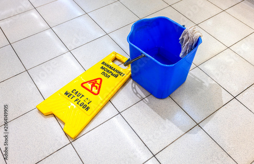 Caution Wet Floor warning sign on a tile floor
