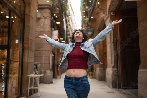 Young woman enjoying freedom and happiness on city street