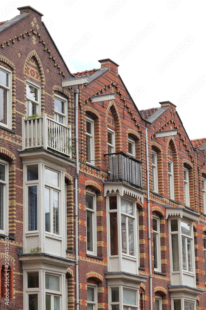 Fototapeta premium Brick House Facades with Ornate Brickwork Decoration in Amsterdam, Oud-West District, Netherlands