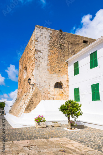 Old fortified tower in the paved courtyard of the Monastery of the Toro Virgin, Menorca Island, Spain