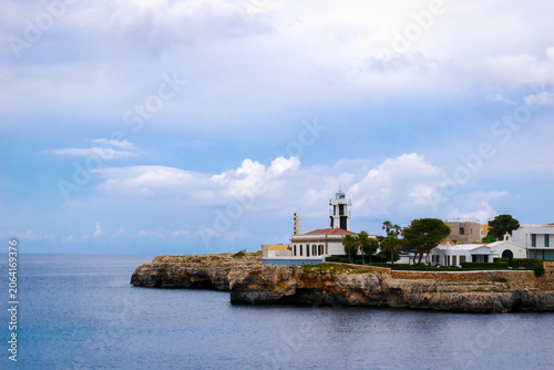 Fotografie Panoramic view of the colorful Far de Ciutadella Lighthouse perched at the entra