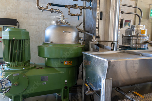 Фотография Industrial centrifugal separator and pipes at olive oil plant