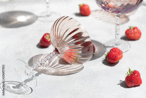 Strawberries and wine glasses on a light background