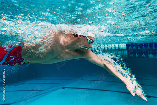 Fotografie Close up of swimmer performing freestyle underwater