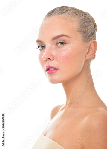 Beautiful face of young adult woman with clean fresh skin. Looking at Camera.