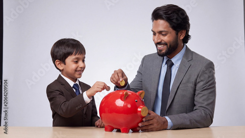 Indian Businessman And Young Boy Saving Money Together For Future Wealth And Financial Growth generative ai