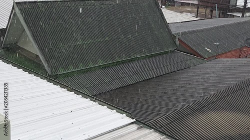 Rain Shower Falling on Multiple Tiled and Metal Roofs