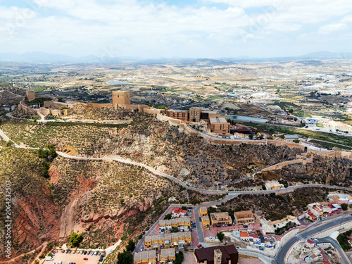 Aerial panoramic view of Lorca urban cityscape with residential buildings and hilltop castle. Travel and touristic places. Murcia, Spain