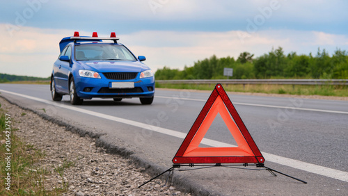 Tableau sur toile Broken Down Car on a Country Roadside with Warning Triangle