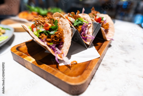 Tableau sur toile Fresh Tacos with Ground Meat, Lettuce, Tomato, and Cabbage Served on Wooden Tray