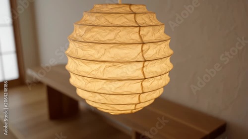 Warm paper lantern glowing indoors during evening