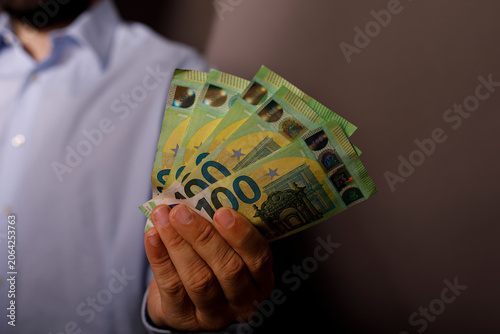 A person's hand displays a ...