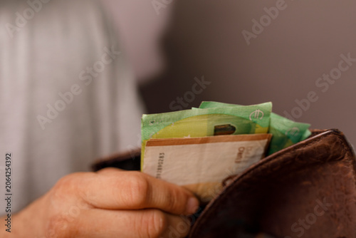 Person holding a brown leat...
