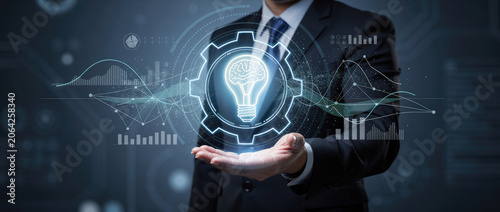 Businessman holding a glowing light bulb inside a gear, symbolizing innovation and business strategy.