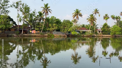 Scenic view of Kerala backwaters with calm waters, lush greenery, and traditional landscape, capturing the serene beauty and tranquil lifestyle of Kerala	
