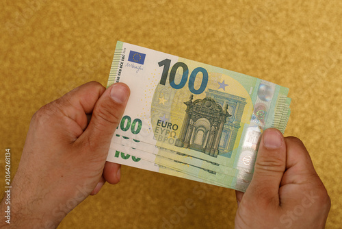 Close up of hands holding a...