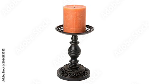 Quadro su tela Orange paraffin candle standing on a dark vintage metal candlestick isolated on