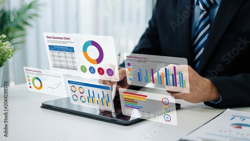 Business person analyzing financial data charts and colorful graphs on a tablet