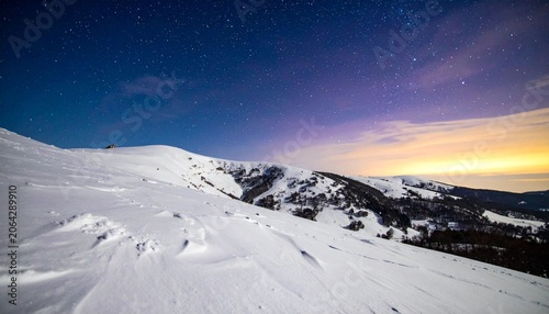 Snowy mountain landscape under starry sky