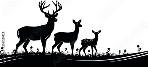 Family of deer standing on grassy hill with flowers