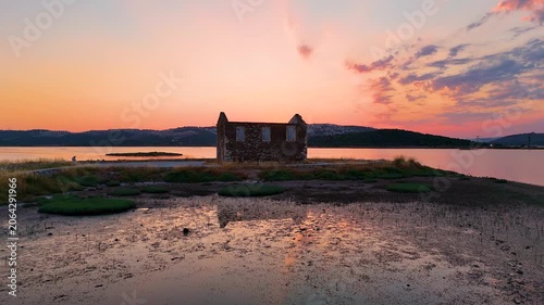 Cinematic Aerial Drone Reveal of Ancient Bargylia Ruins at Golden Hour Sunset, Stone Building Reflection in Lagoon, Aegean Coast, Bogazici Milas Mugla Turkey