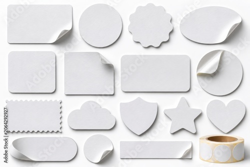 Collection of various white sticker shapes and sizes on white background