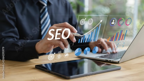 Businessman using laptop with digital seo marketing growth charts and data icons