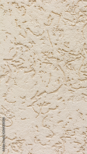 Beige plaster wall texture, decorative stucco surface with rough relief patterns