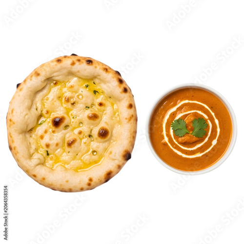 Indian butter chicken served with garlic naan bread, in a white bowl, overhead view on a clear background.