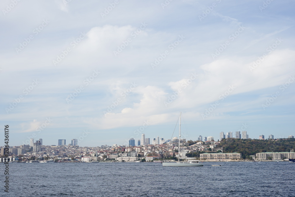 Fototapeta premium Scenic Istanbul Waterfront Skyline With Sailboat On Bosphorus Coast