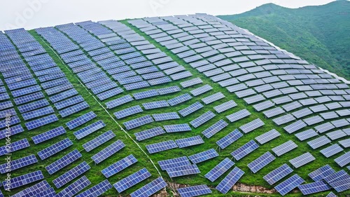 Aerial View of Solar Panels on Green Hillside Agrivoltaics Concept