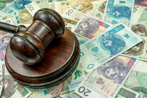 Judge's gavel and Polish zloty banknotes