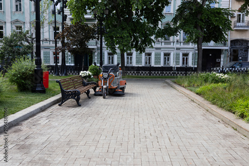 Canvastavla Compact electric street sweeper machine parked on city pavement, urban maintenan