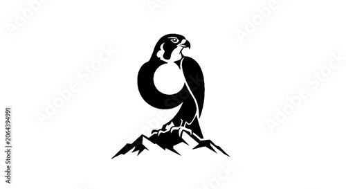 Silhouette of a majestic peregrine falcon perched on mountains.