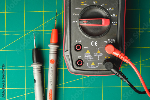 Fotografie Exploring electronics with a digital multimeter on a vibrant workbench