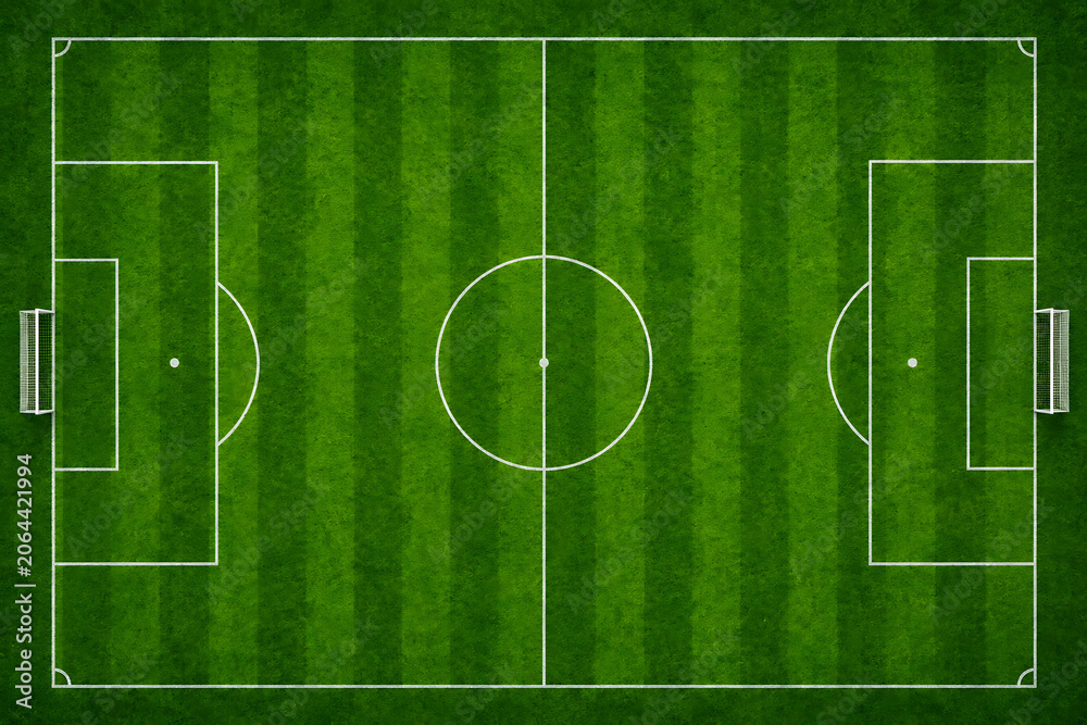 Obraz premium Soccer field from above with green turf and white markings during daytime