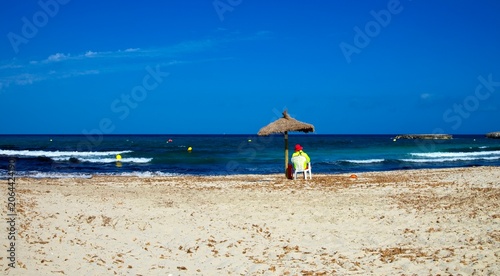 Lifeguard on the beach of Cala Moreia in the resort of S´illot on the island of Mallorca in the Balearic Islands in Spain.