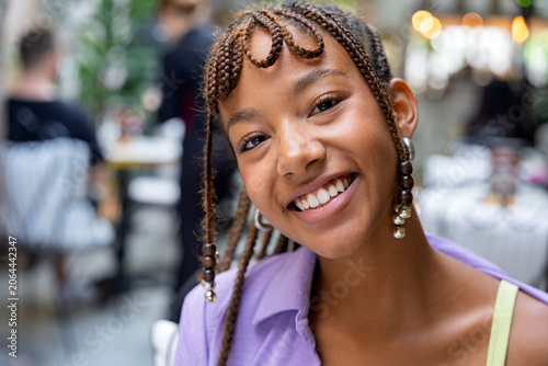 Young woman smiling enjoying social gathering outdoors