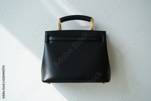 Elegant black leather handbag with gold hardware and a structured top handle