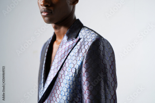 Man wearing stylish iridescent honeycomb pattern blazer, close up