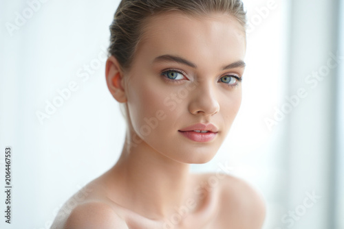 Close up beauty portrait of a young woman with blue eyes