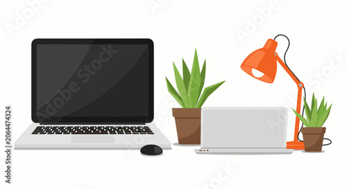 A laptop computer and tablet with a mouse, plants, and a desk lamp